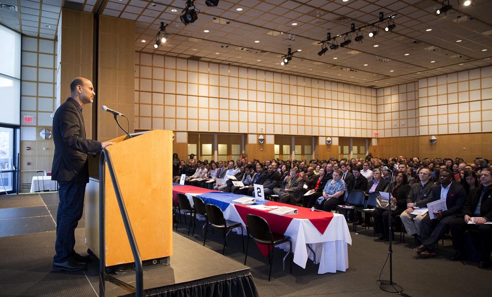 Mohamad Ali, the CEO of Carbonite, shared his own immigrant story during a naturalization ceremony at the JFK Library on Wednesday. (Robin Lubbock/WBUR)