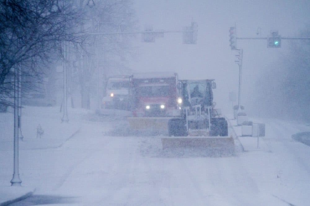 Plows moved quickly across a snow-covered Bennington Street in East Boston. (Jesse Costa/WBUR)