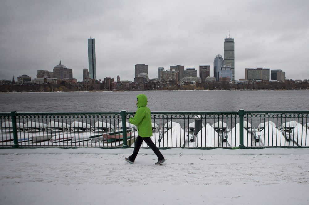 A woman got in a morning walk on Memorial Drive before the storm. (Jesse Costa/WBUR)