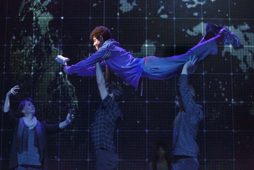 The cast hoists Adam Langdon's Christopher Boone in "The Curious Incident of the Dog in the Night-Time." (Courtesy Boston Opera House)