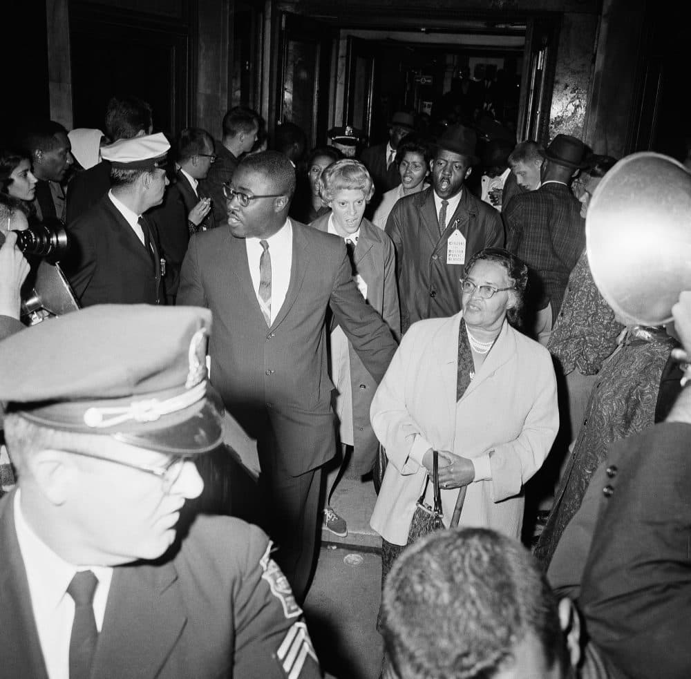 A group of 45 members of the NAACP led by Boston leader Kenneth Guscott, left, leave headquarters of the Boston School Committee on Sept. 7, 1963, after staging a three-day sit-in protesting what they term de facto segregation in Boston schools. Guscott walks with Melnea Cass, right, who was president of the NAACP's Boston branch before him. (AP/FCC)