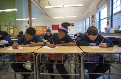 Boston Collegiate Charter School students from Bridget Adam's math class work on a problem involving median, mean and mode. (Jesse Costa/WBUR)