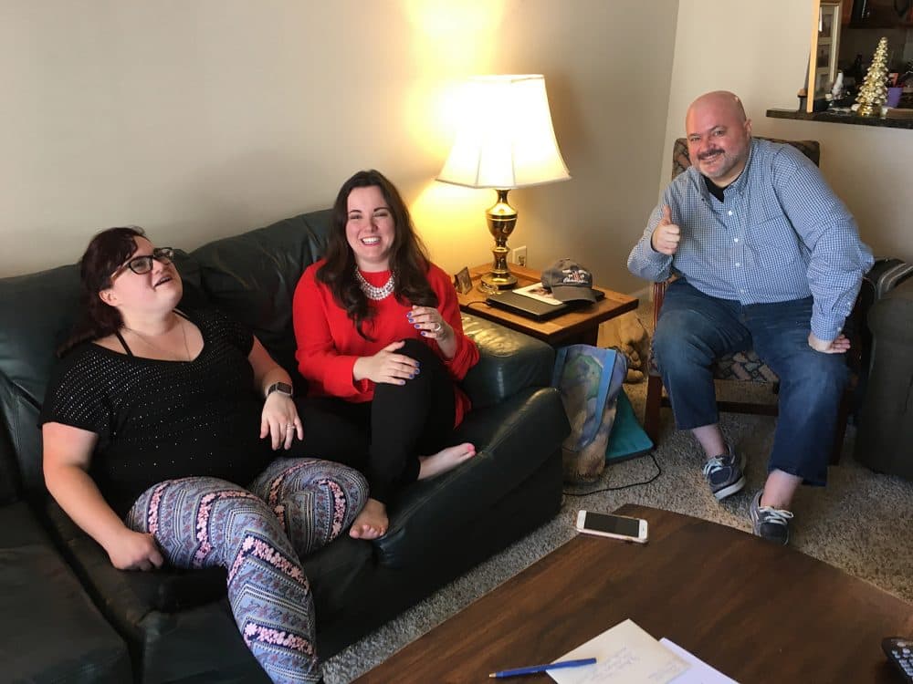 From left, Niki Ilse, Kelly Best and Sean Bunn in Sean's living room. (Lynn Jolicoeur/WBUR)