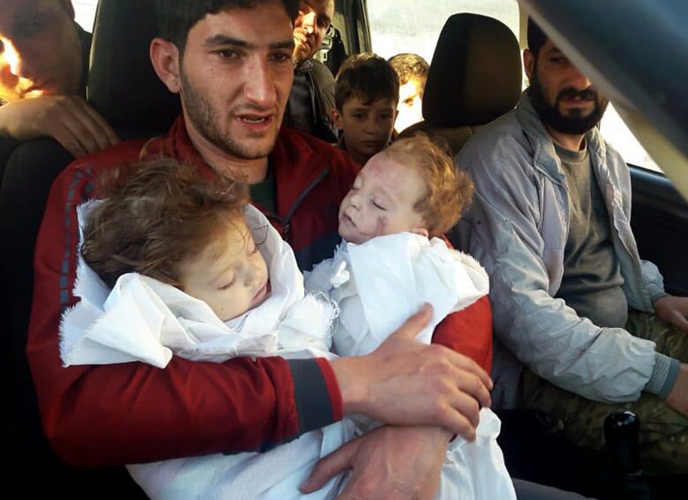 Sabdul-Hamid Alyousef, 29, holds his twin babies who were killed during a suspected chemical weapons attack, Tuesday in Khan Sheikhoun in the northern province of Idlib, Syria. Alyousef also lost his wife, two brothers, nephews and many other family members in the attack that claimed scores of his relatives. (Alaa Alyousef/AP)