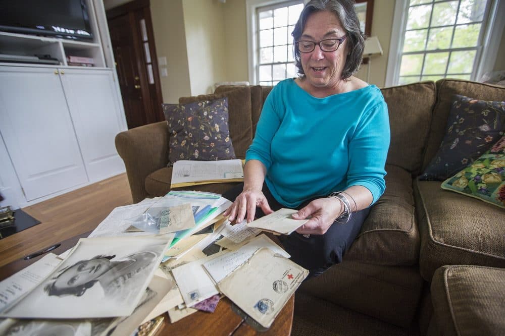 Betsy Fermano opens a plastic bag containing letters from Ernest Hemingway to her grandmother Frances Elizabeth Coates. (Jesse Costa/WBUR)