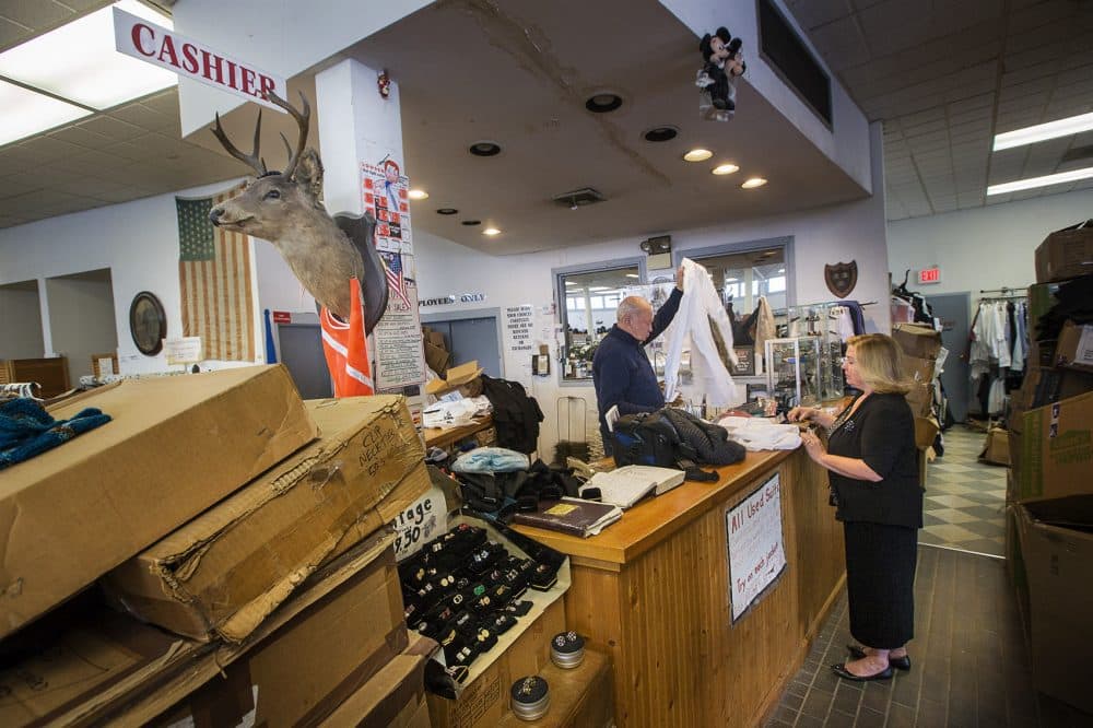 A Keezer's staff member rings up a customer. The store has no big computers or fancy technology, just pads of sales slips and small credit card machines. (Jesse Costa/WBUR)