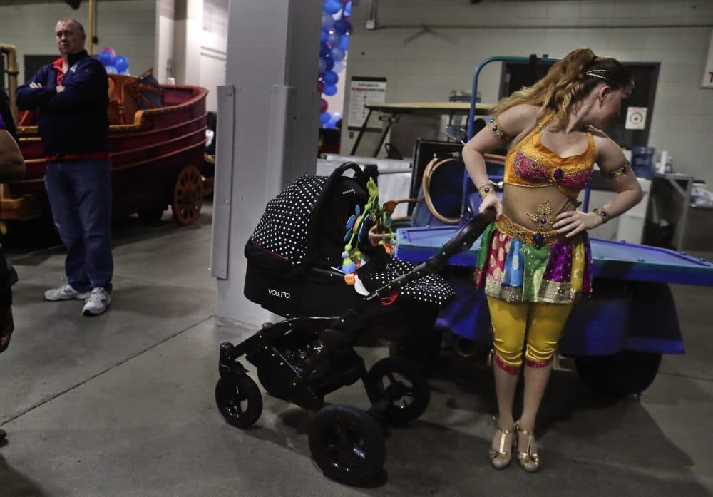 Ringling Bros. high wire performer Anna Lebedeva stands next to her 3-month-old son, Amir, in his stroller while waiting to go on for the show's finale on May 5. (Julie Jacobson/AP)