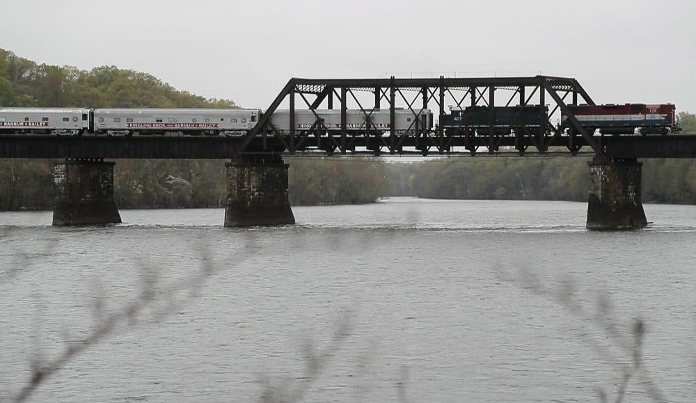 The Ringling Bros. and Barnum & Bailey Circus red unit train passes over a bridge in Enfield, Conn. on its way to Providence, R.I. It is the last circus to travel by train. (Julie Jacobson/AP)
