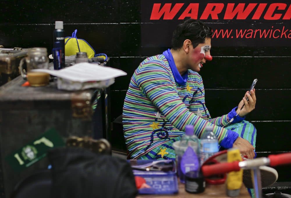 Ringling Bros. clown Ivan Vargas speaks on a video call with his parents during the intermission of a show on May 5. (Julie Jacobson/AP)
