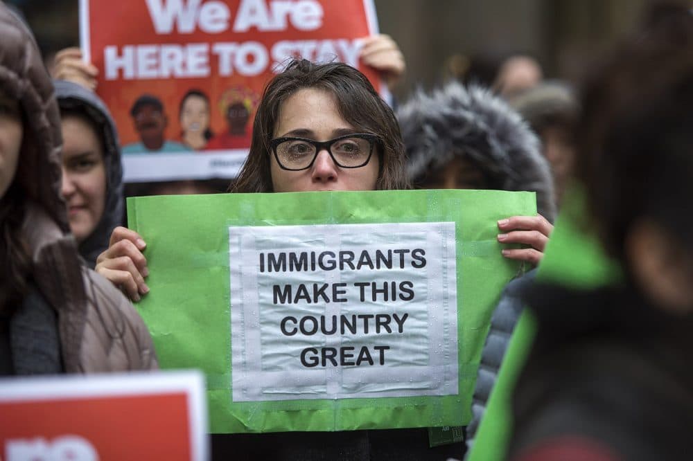 During a SEIU immigrant rally in Boston back in January, a woman holds a sign that reads, "Immigrants Make This Country Great.". (Jesse Costa/WBUR)