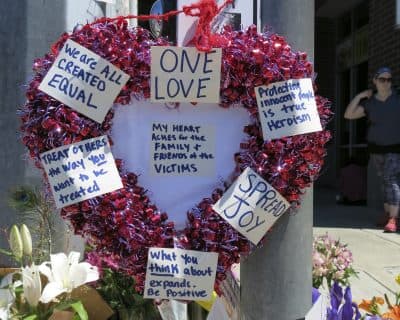 A heart-shaped wreath covered with positive messages hangs on a traffic light pole at a memorial for two bystanders who were stabbed to death Friday, while trying to stop a man who was yelling anti-Muslim slurs and acting aggressively toward two young women, including one wearing a Muslim head covering, on a light-trail train in Portland, Ore, Saturday, May 27, 2017. (Gillian Flaccus/AP)