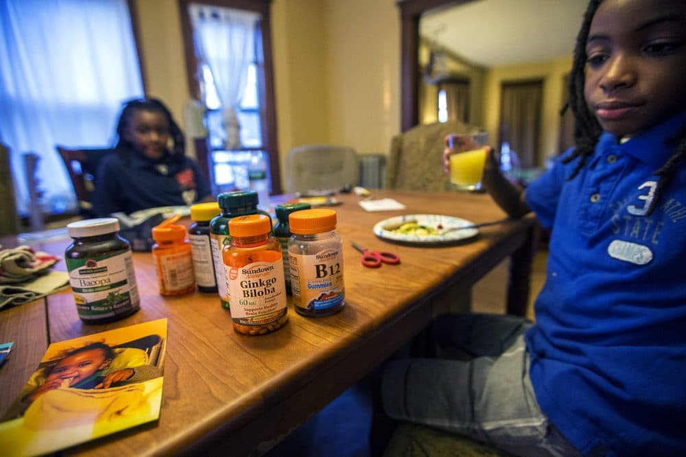 Each morning Beverly Hiliare gives both Stephen and Harrison a cocktail of over-the-counter supplements to help them with clarity. (Jesse Costa/WBUR)