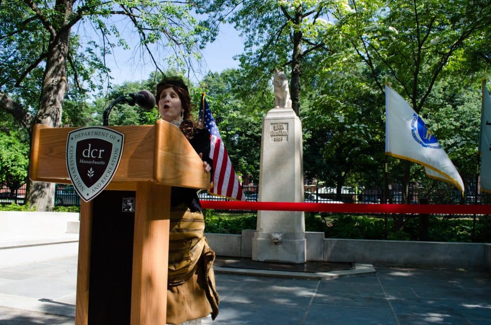 Joan Covino, dressed as Lotta Crabtree, sings "Old Susanna" at the reopening's ribbon cutting. (Elizabeth Gillis/WBUR)