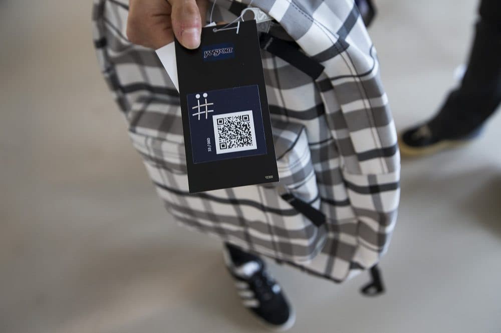 A JanSport backpack capable of storing information in its fabric that can then be accessed using an app on a smartphone. The QR code here allows the backpack owner to connect their bag to the AFFOA Looks app. Then other people with the app can scan the backpack itself and see what the backpack owner has uploaded. (Jesse Costa/WBUR)