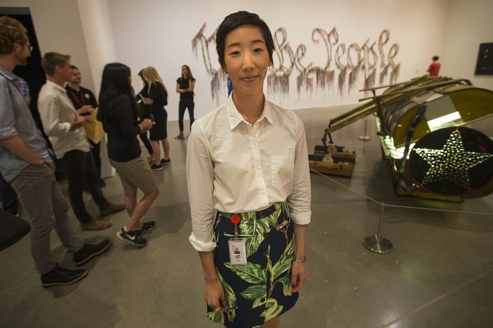 Jessica Hong, curatorial associate at the Institute of Contemporary Art in Boston, standing in the Nari Ward exhibit. (Jesse Costa/WBUR)