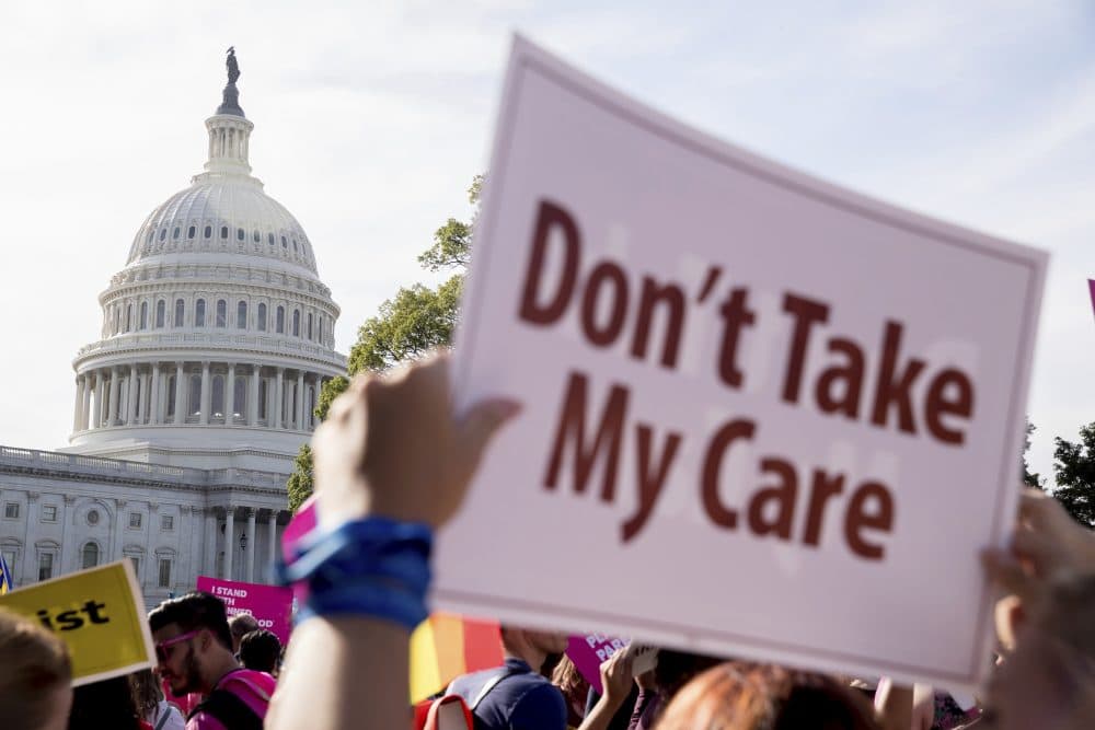 A large group of protesters rally against the Senate Republican health care bill on the East Front of the Capitol Building in Washington on Wednesday. (Andrew Harnik/AP)