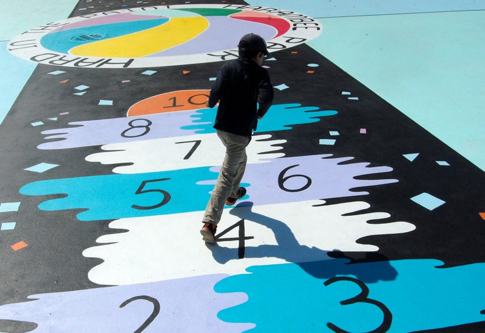 The hopscotch court running up the middle of Maria Molteni's "Hard In the Paint" basketball court mural at Boston's Harambee Park. (Greg Cook)