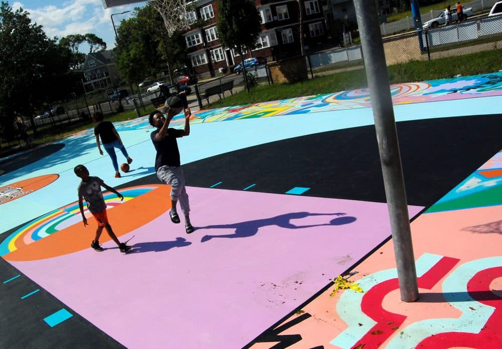 Playing on Maria Molteni's "Hard In the Paint" basketball court mural at Boston's Harambee Park. (Greg Cook)