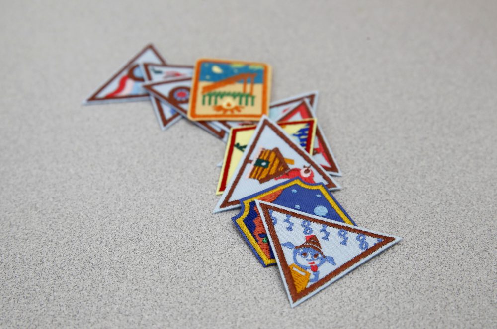 In this July 21, 2017 photo, a Girl Scout badge for learning how to program a robot is seen atop a sample of new badges focused on science, technology, engineering and math in Owings Mills, Md. (Patrick Semansky/AP)
