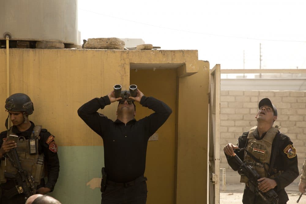 An Iraqi special forces soldier watches for militant drones during heavy fighting to wrest the al-Tanek neighborhood of Mosul, Iraq from Islamic State militants on Tuesday, April 18, 2017. (Maya Alleruzzo/AP)
