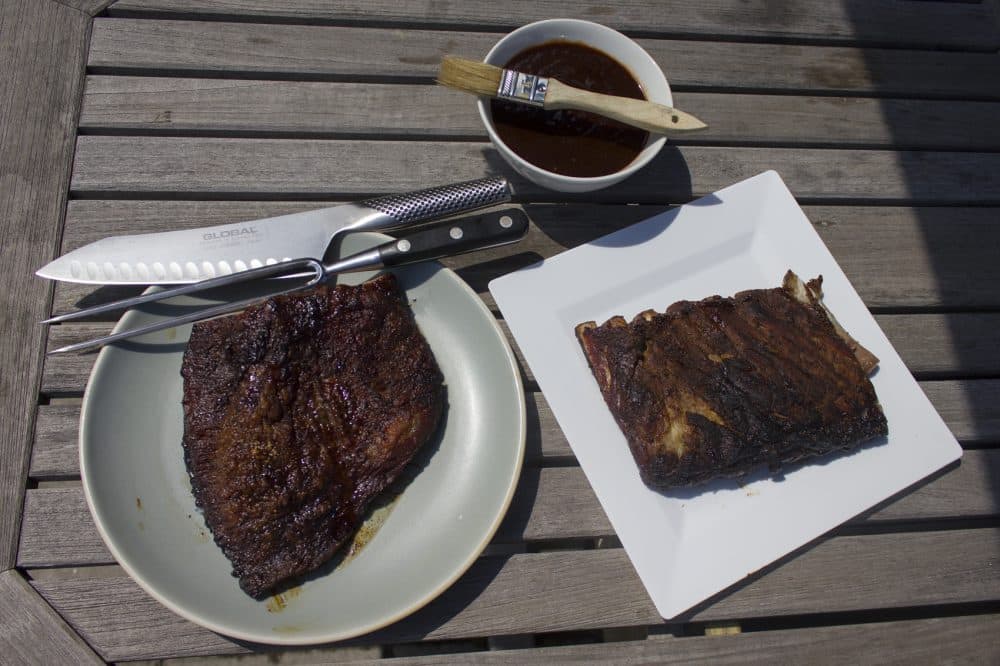 Kathy's slow-smoked Texas-style brisket (left), dry-rubbed pork ribs and best barbecue sauce. (Jackson Mitchell/Here & Now)