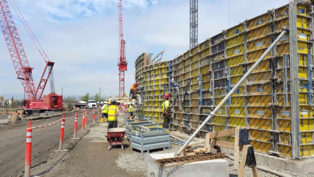 Workers install the "pedestal" that the first floor of the Wynn Boston Harbor casino will sit on -- 11 feet above the ground -- to prevent flooding. (Courtesy Wynn)