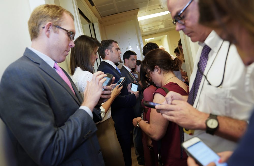 Members of the media gather outside the entrance to the White House press office on July 21, 2017. (Pablo Martinez Monsivais/AP)