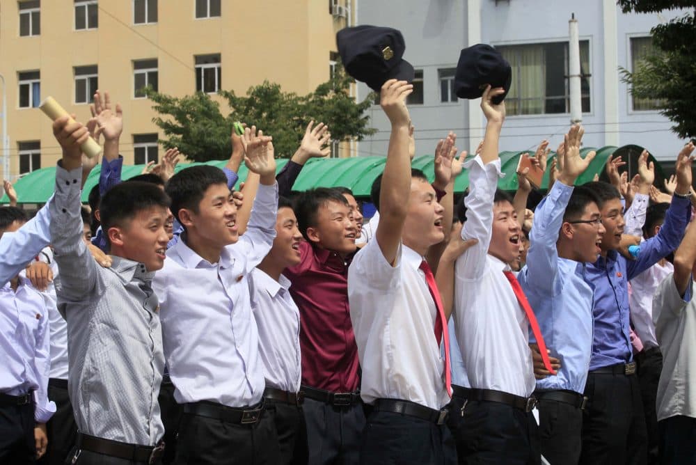 People react while watching a news broadcast on a missile launch in Pyongyang, North Korea, on Saturday. North Korean leader Kim Jong Un said the flight demonstrated his country can hit the U.S. mainland. (Jon Chol Jin/AP)