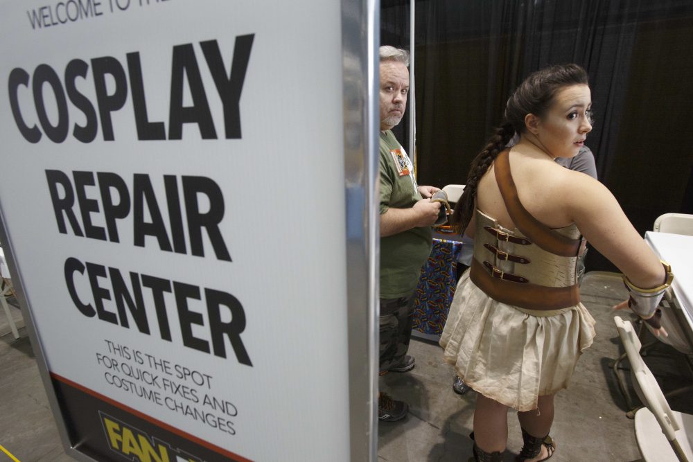 Morgan Prittie, right, of Derry, New Hampshire, adjusts her costume in a booth. (Michael Dwyer/AP)