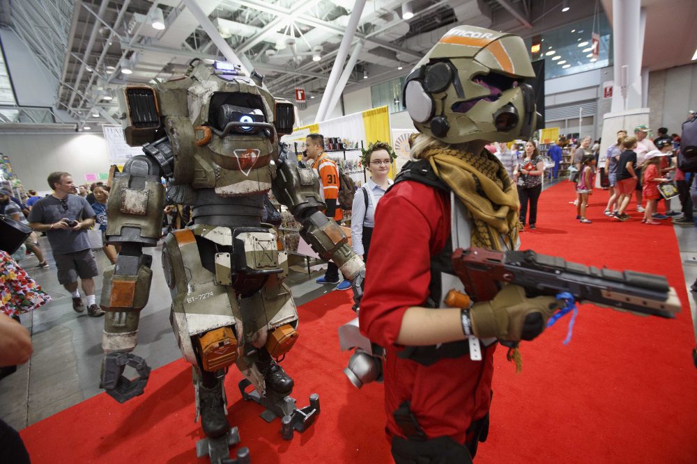 BT from Titan Fall 2, left, and its pilot walks on the display floor. (Michael Dwyer/AP)