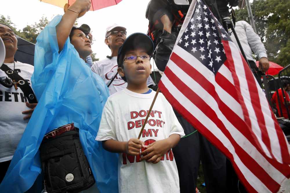 Michael Claros, 8, of Silver Spring, Md., attends a rally in favor of immigration reform, on Aug. 15, 2017, at the White House. He's a U.S. citizen whose parents would have been eligible for Deferred Action for Parents of Americans, an Obama era policy memo that the Trump administration has since revoked. (Jacquelyn Martin/AP)