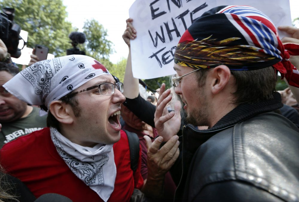 A counter-protester, left, confronts a professed supporter of President Trump. (Michael Dwyer/AP)