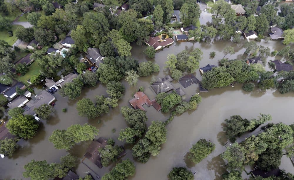 Homes are surrounded by floodwaters from Tropical Storm Harvey Tuesday, Aug. 29, 2017, in Spring, Texas. (David J. Phillip/ AP)