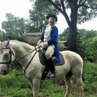 Philip Smucker, wearing colonial garb, rides along a trail in Plains, Virginia. (Shannon Venezia)