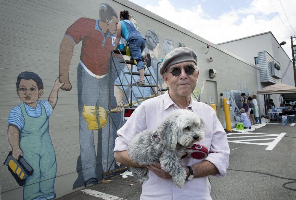 Artist Bernie LaCasse, 74, with his dog Misty Moonlight in front of his "Beat the Belt" mural in Cambridgeport. (Robin Lubbock/WBUR)