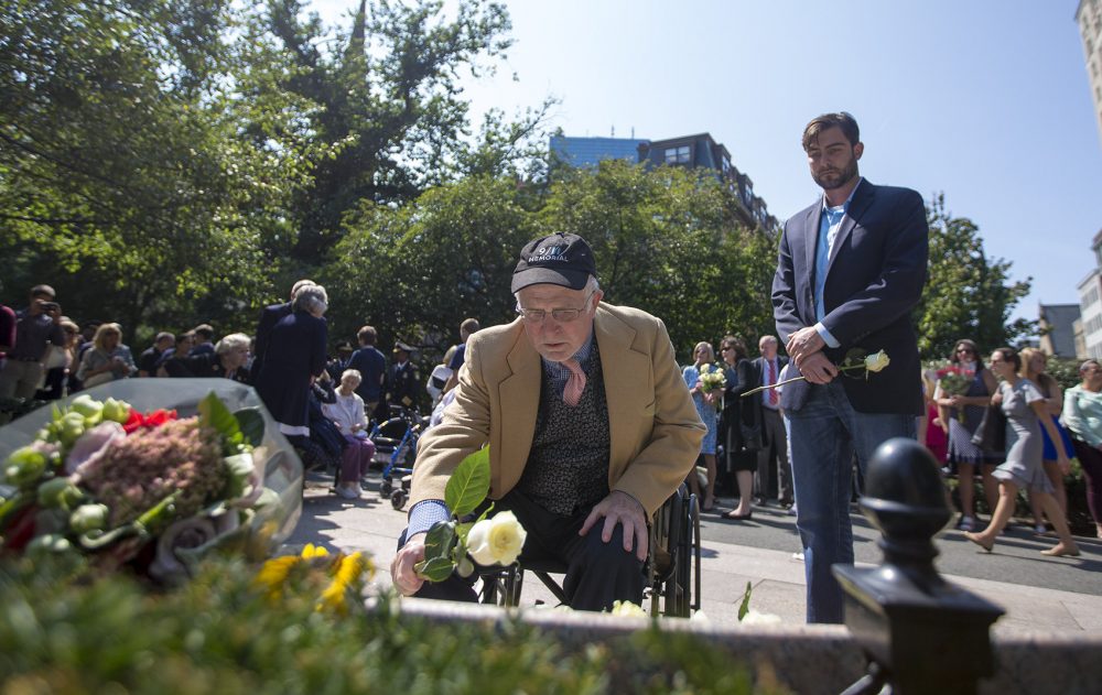 William Connors lays a flower on the memorial for his brother, Kevin Patrick Connors, who was on the 85th floor of the South Tower of the World Trade Center. (Jesse Costa/WBUR)