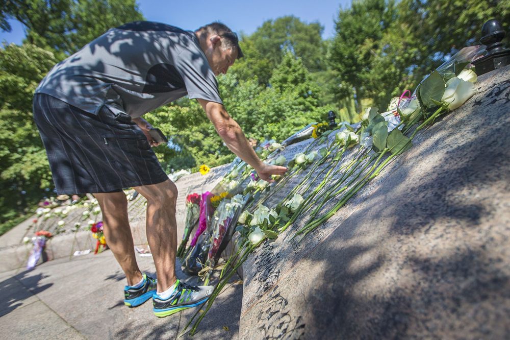 Robert Landrum leaves a flower and touches the name of his then fiance, Betty Ann Ong, the flight attendant on American Airlines Flight 11 who alerted authorities by phone that the plane had been hijacked. (Jesse Costa/WBUR)