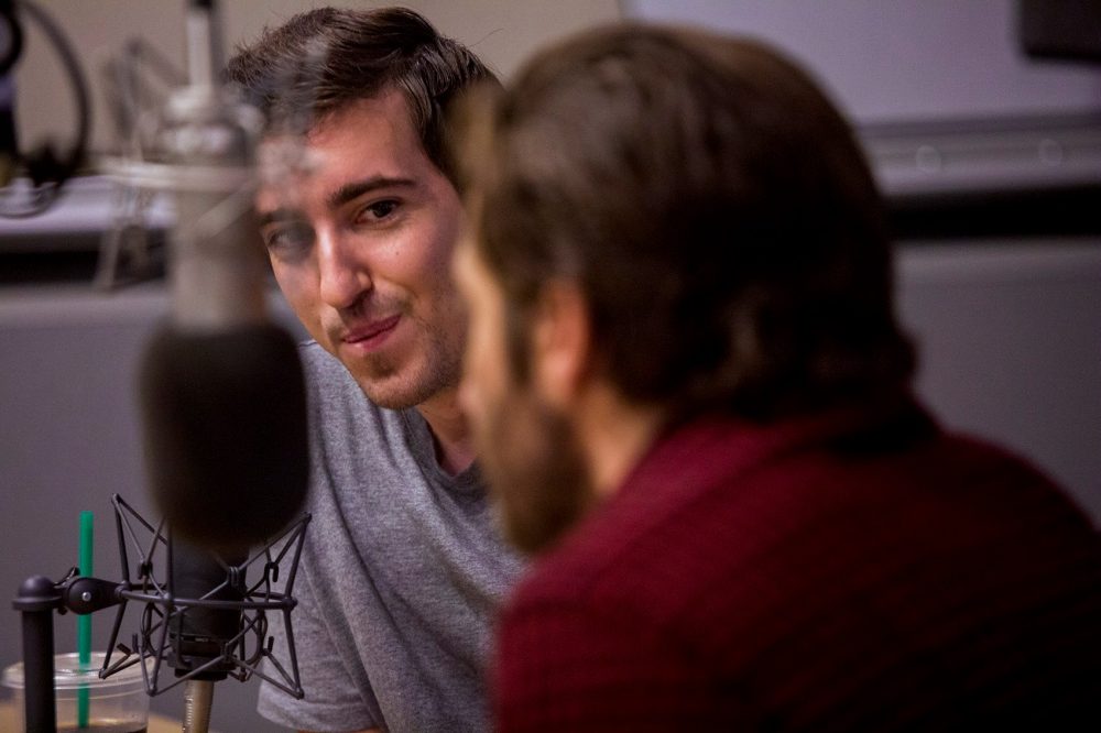 Boston Marathon bombing victim Jeff Bauman looks at Jake Gyllenhall during an interview on Here & Now. (Jesse Costa/WBUR)