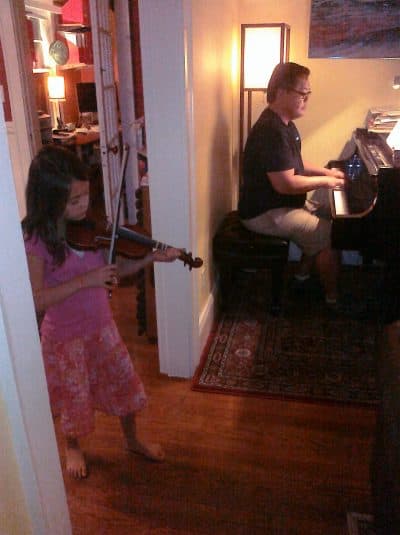 Jojo David plays the piano with his daughter, Madeline. (Courtesy Anne Marie David)