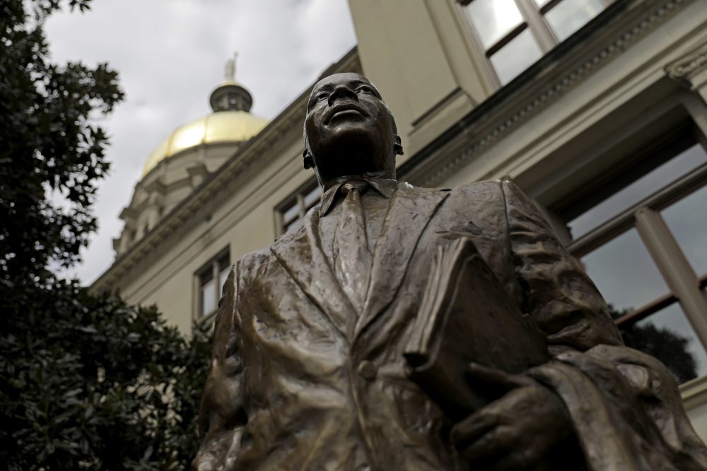 A statue paying tribute to civil rights leader Martin Luther King Jr. is unveiled on the state Capitol grounds in Atlanta on Aug. 28. It was unveiled on the 54th anniversary of King's "I have a dream" speech. (David Goldman/AP)