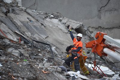 A rescuer and a firefighter search for survivors in a flattened building in Mexico City on Sept. 21, 2017, as the search for survivors continues two days after a strong quake hit Central Mexico. (Yuri Cortez/AFP/Getty Images)
