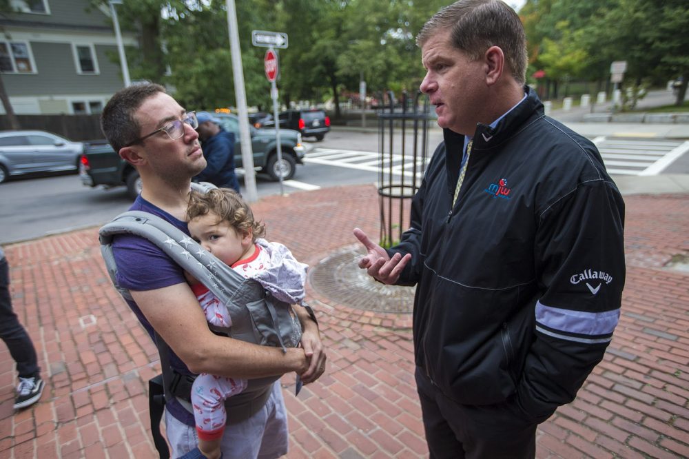 Boston Mayor Marty Walsh speaks with Jamaica Plain resident Eliav Kahan outside Green Street Station ahead of the upcoming preliminary election. (Jesse Costa/WBUR)