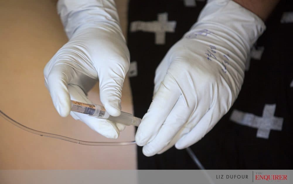 Covington paramedics administer the lifesaving medication naloxone intravenously to Gracie Centers after she overdosed in Covington. (Courtesy Liz Dufour/Cincinnati Enquirer)