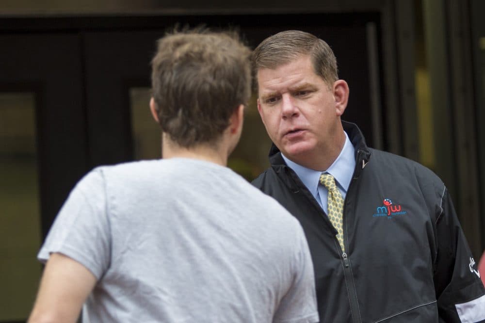 Boston Mayor Marty Walsh greets voters outside Green Street Station in Jamaica Plain on Sept. 21. (Jesse Costa/WBUR)