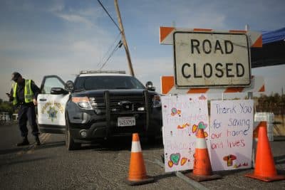 Handmade signs are seen attached to a road closure sign on Oct. 16, 2017 in Oak Knoll, Calif. (Elijah Nouvelage/Getty Images)