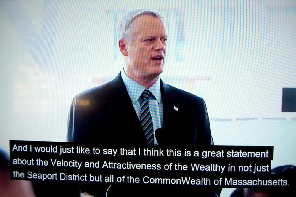 Massachusetts Gov. Charlie Baker appears to speak in a doctored video for the imagined groundbreaking of the "Luxury Waters" condo tower. (Greg Cook/WBUR)
