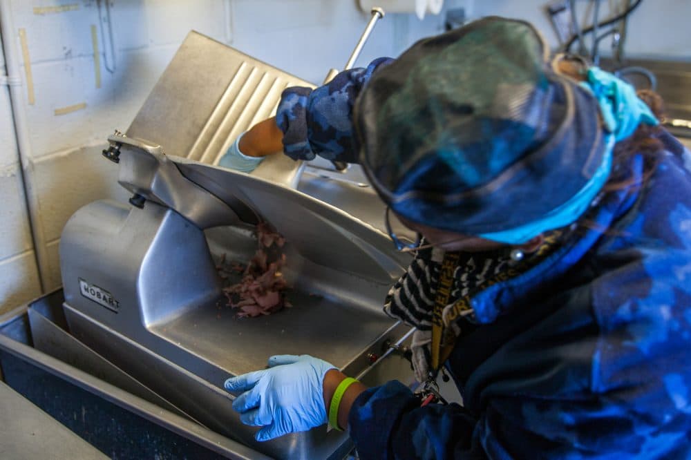 Deborah Jones slices brisket at Jones BBQ in Kansas City, Kan. (Dean Russell/Here & Now)