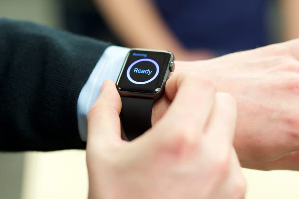 An excited customer tries on the Apple Watch at the Eaton Centre Apple Store on Friday, April 10, 2015 in Toronto. (Ryan Emberley/Invision for Apple/AP)
