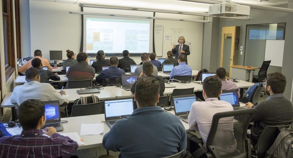 Kayvan Sabery, an instructor of information technology, talks to his class at Year Up. (Robin Lubbock/WBUR)