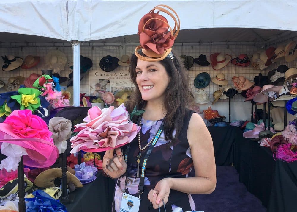 Christine Moore, owner of Christine A. Moore Millinery, selling hats at the track. (Alex Ashlock/Here & Now)